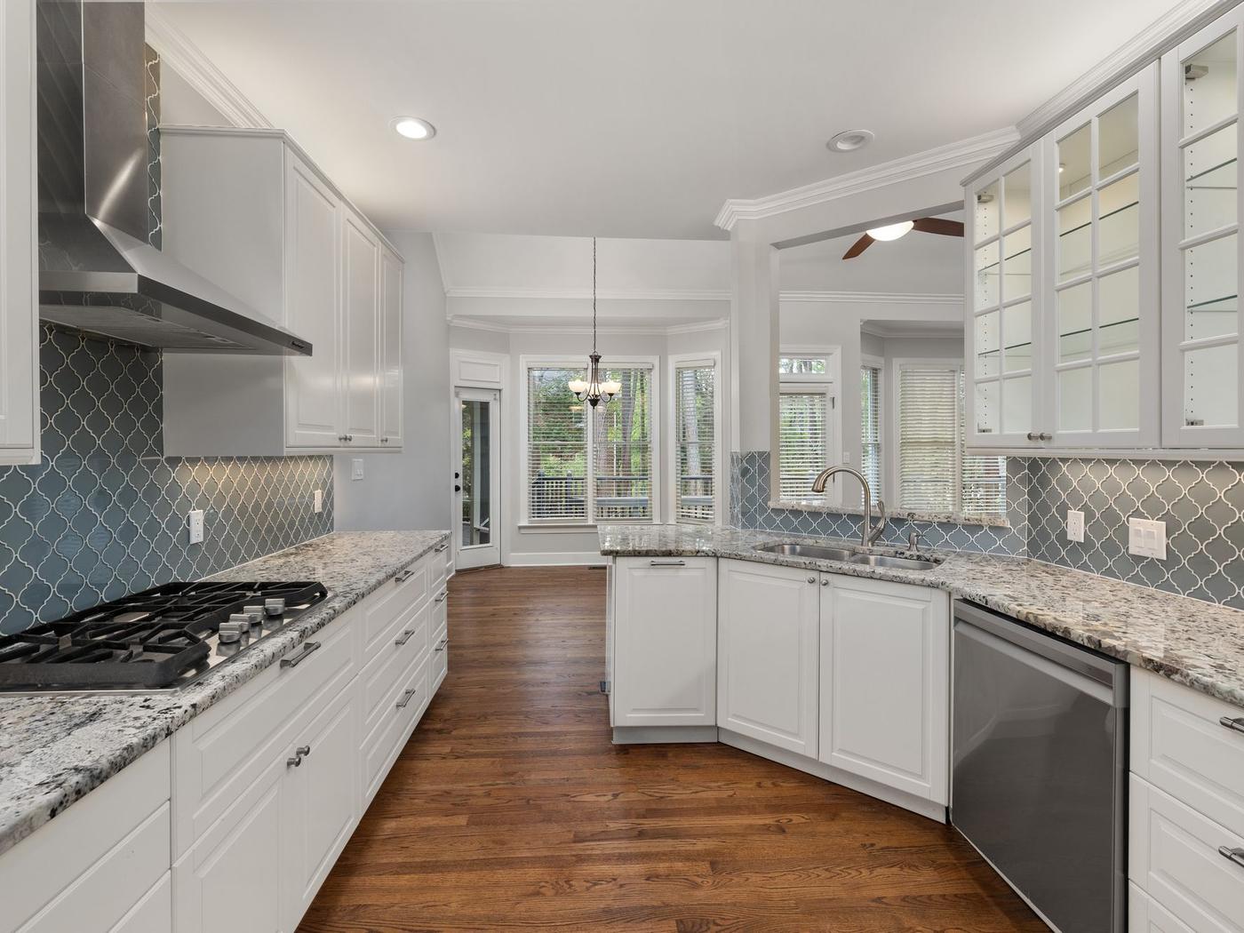 Updated white kitchen with granite counters, an example of home remodeling in Benton AR