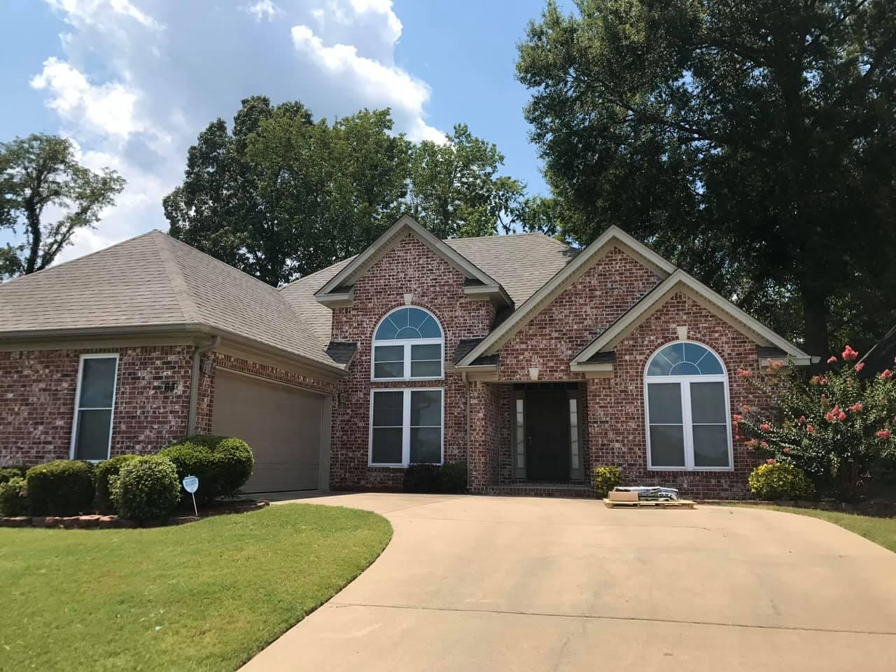 New shingle roof on a brick house with arched windows, roof replacement in Benton AR