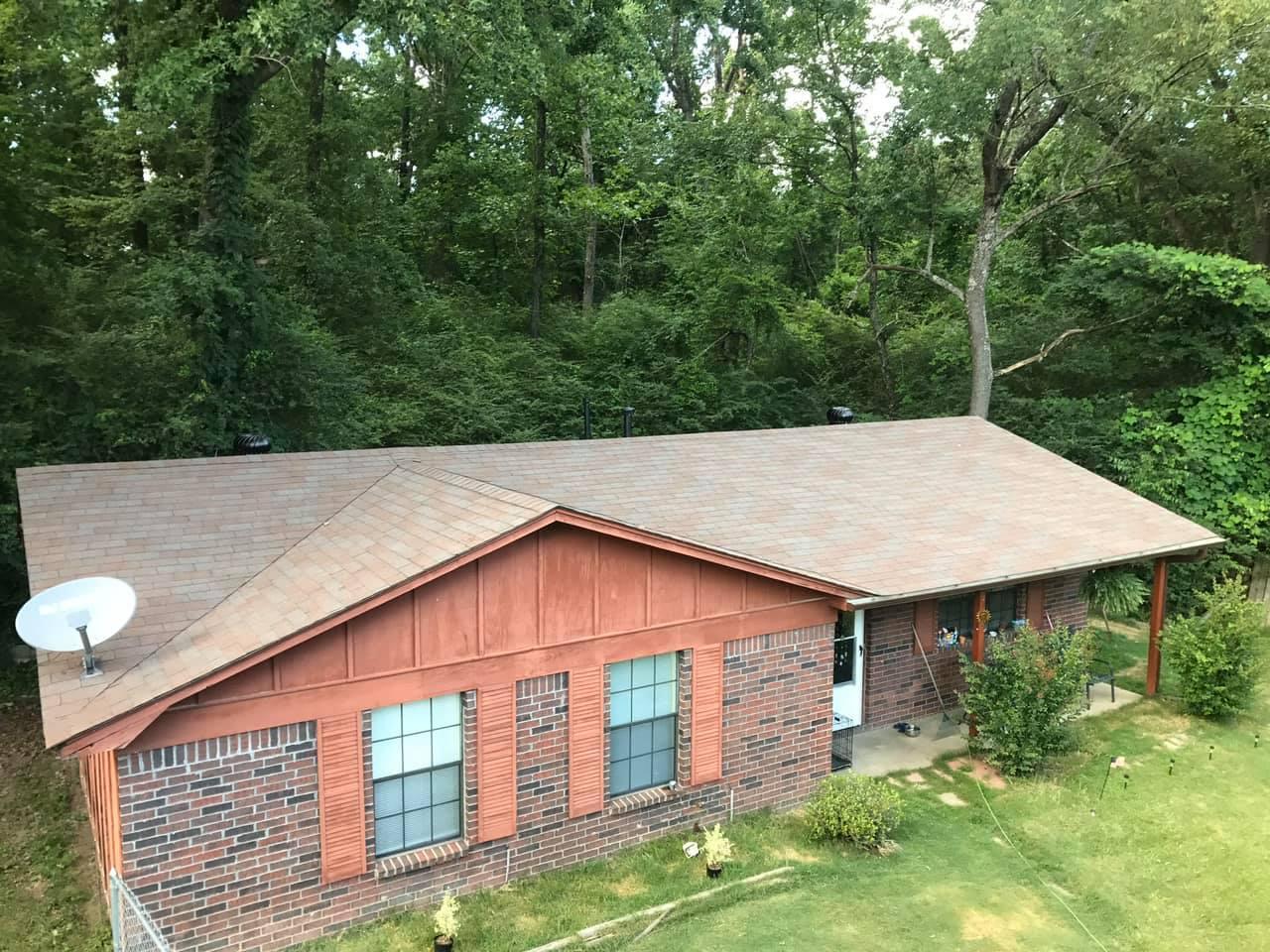 Brick and red siding home with a new shingle roof, roof replacement in central Arkansas